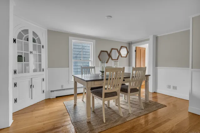 a view of a dining room with furniture and wooden floor