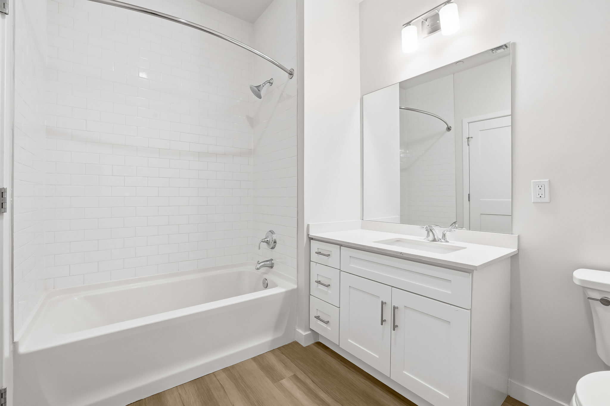 71 Connecticut Avenue, Unit 204 Norwalk, CT 06850 - Photo 18 of 19 a bathroom with a bathtub shower sink vanity and toilet