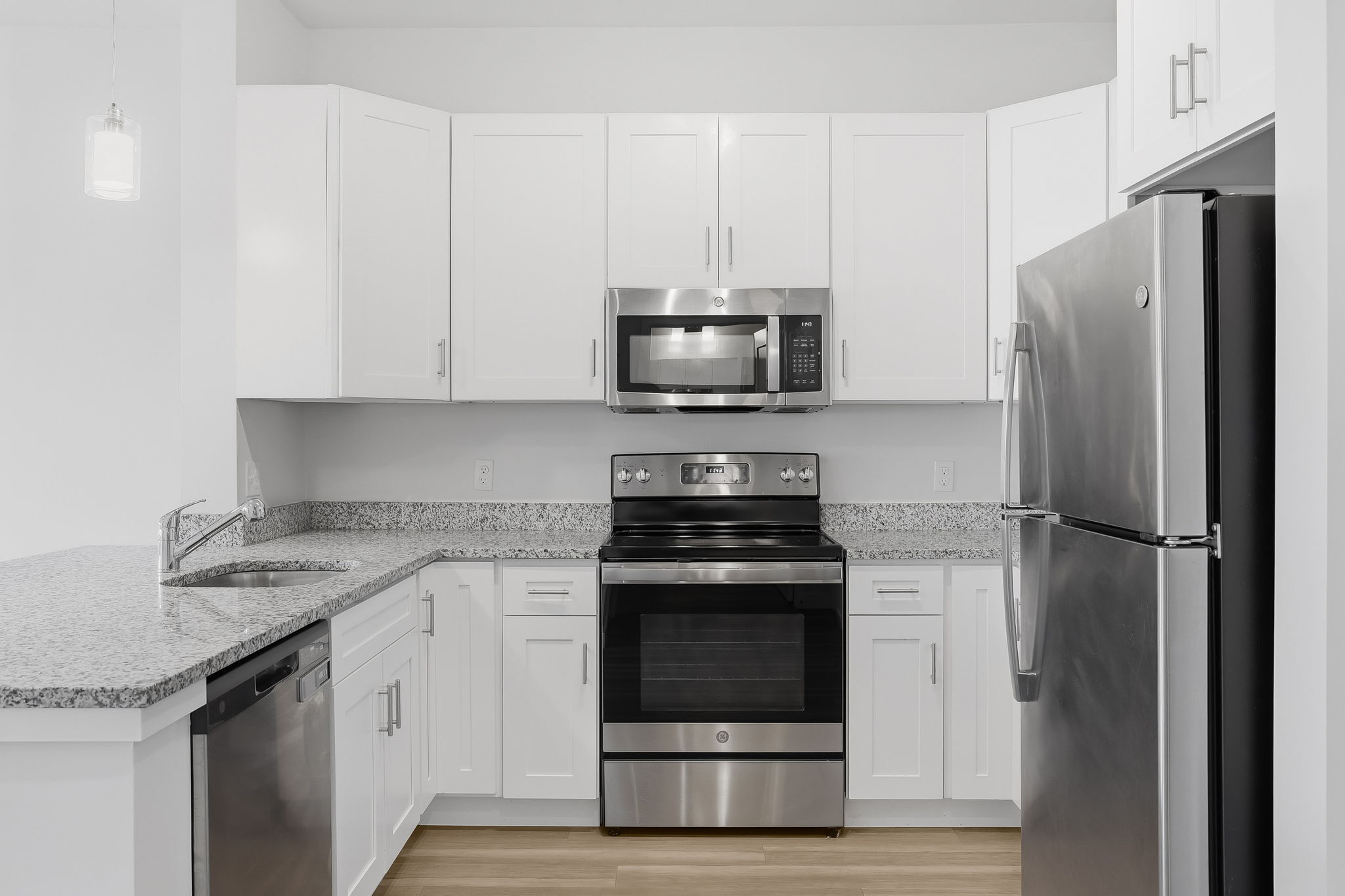 71 Connecticut Avenue, Unit 204 Norwalk, CT 06850 - Photo 9 of 19 a kitchen with stainless steel appliances granite countertop a stove a refrigerator and a microwave