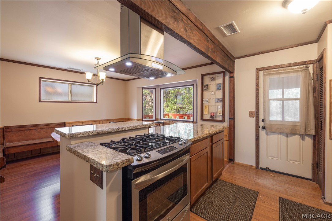 773 Sunset Lane Sugarloaf, CA 92386 - Photo 6 of 33 a kitchen with a stove and wooden floor