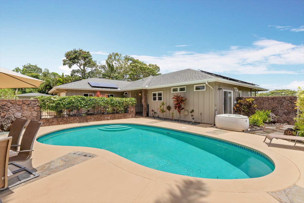 6154 Olohena Road, Unit 2 Kapaa, HI 96746 - Photo 1 of 27 a view of pool with lawn chairs and plants