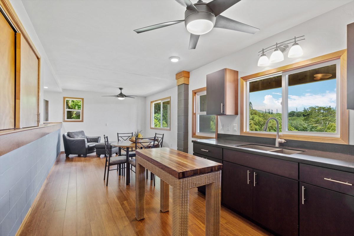6154 Olohena Road, Unit 2 Kapaa, HI 96746 - Photo 23 of 27 a kitchen with sink stove and wooden floor