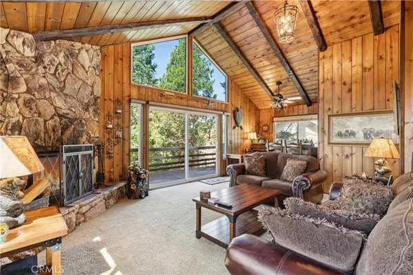 a living room with furniture a fireplace and next to a window