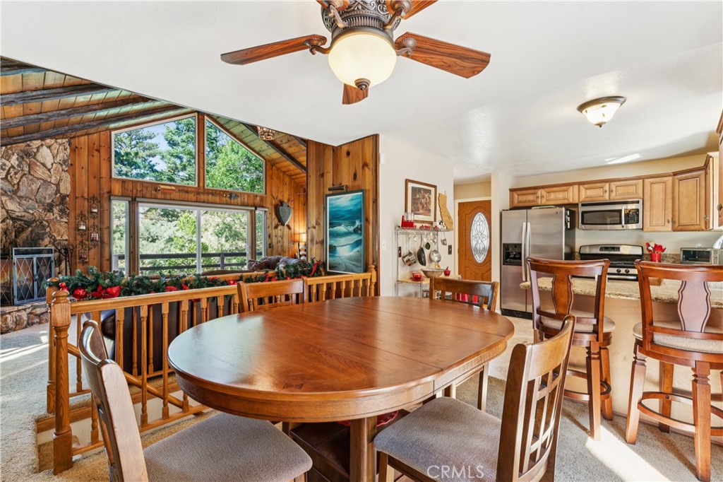 460 Pioneer Road Lake Arrowhead, CA 92352 - Photo 15 of 48 a dining room with furniture a chandelier and wooden floor