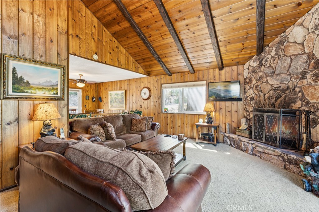 460 Pioneer Road Lake Arrowhead, CA 92352 - Photo 18 of 48 a large bedroom with a bed and wooden floor