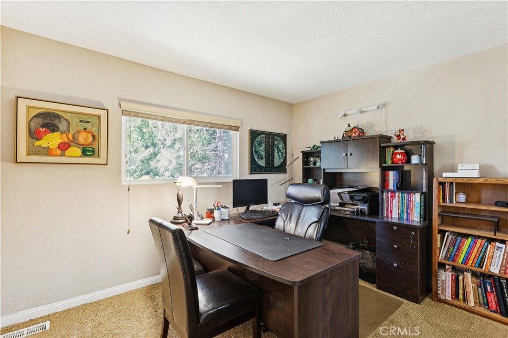 460 Pioneer Road Lake Arrowhead, CA 92352 - Photo 26 of 48 a view of a workspace with furniture and a bookshelf