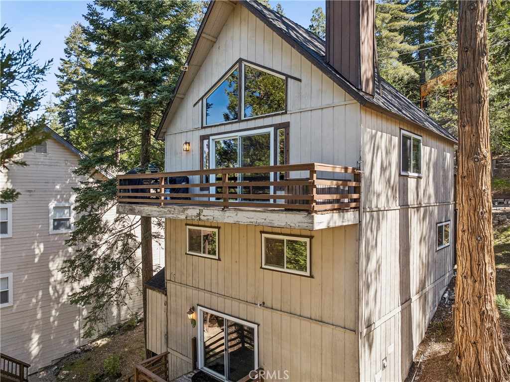 460 Pioneer Road Lake Arrowhead, CA 92352 - Photo 39 of 48 a aerial view of a house with balcony and car parked