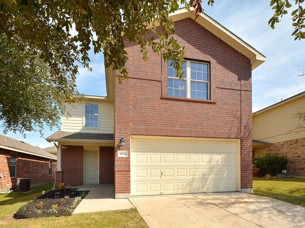 5604 Silver Screen Drive Austin, TX 78747 - Photo 1 of 1 a front view of a house with a yard