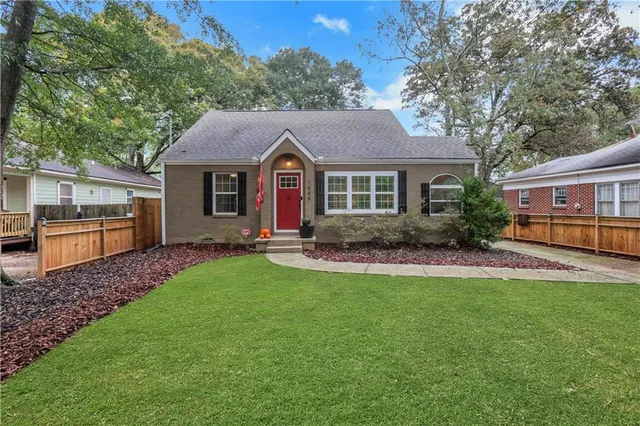 a front view of a house with a garden and yard