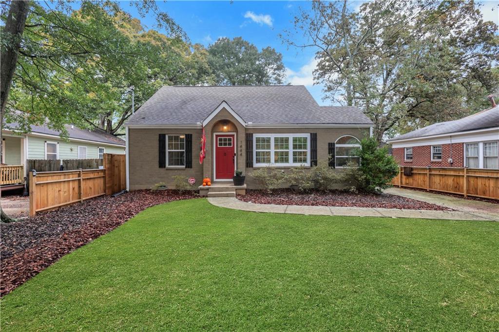 a front view of a house with a garden and yard