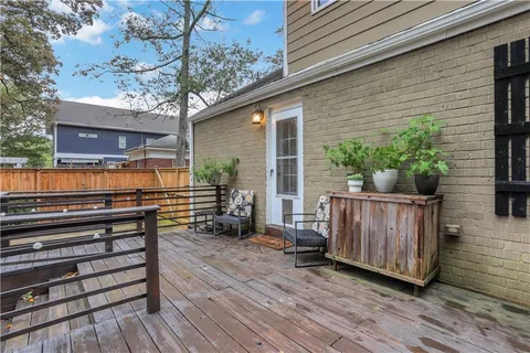 a backyard of a house with large trees and plants