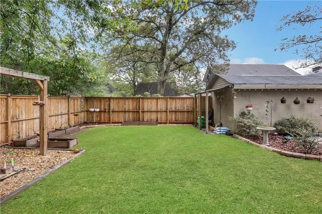 a view of house with a yard