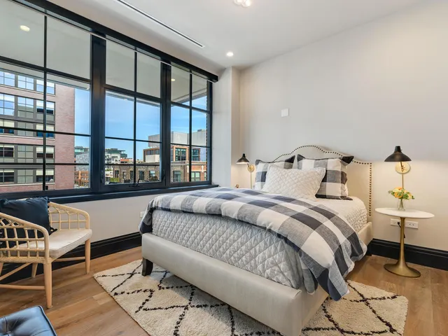 a living room with furniture and a floor to ceiling window
