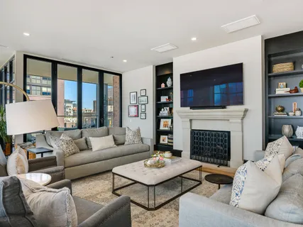 a living room with furniture a flat screen tv and a fireplace