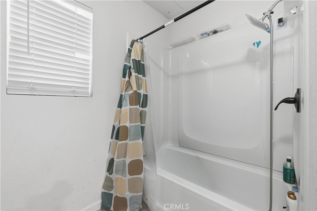 5885 Dos Palmas Road Phelan, CA 92371 - Photo 26 of 40 a bathroom with a bathtub and shower