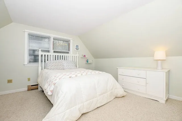 a bedroom with a bed and a night stand