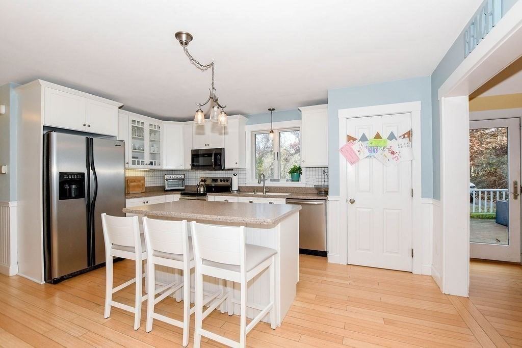 150 Herring Pond Road Bourne, MA 02532 - Photo 2 of 42 a kitchen with stainless steel appliances granite countertop a refrigerator a microwave oven a refrigerator a sink and dishwasher with wooden floor
