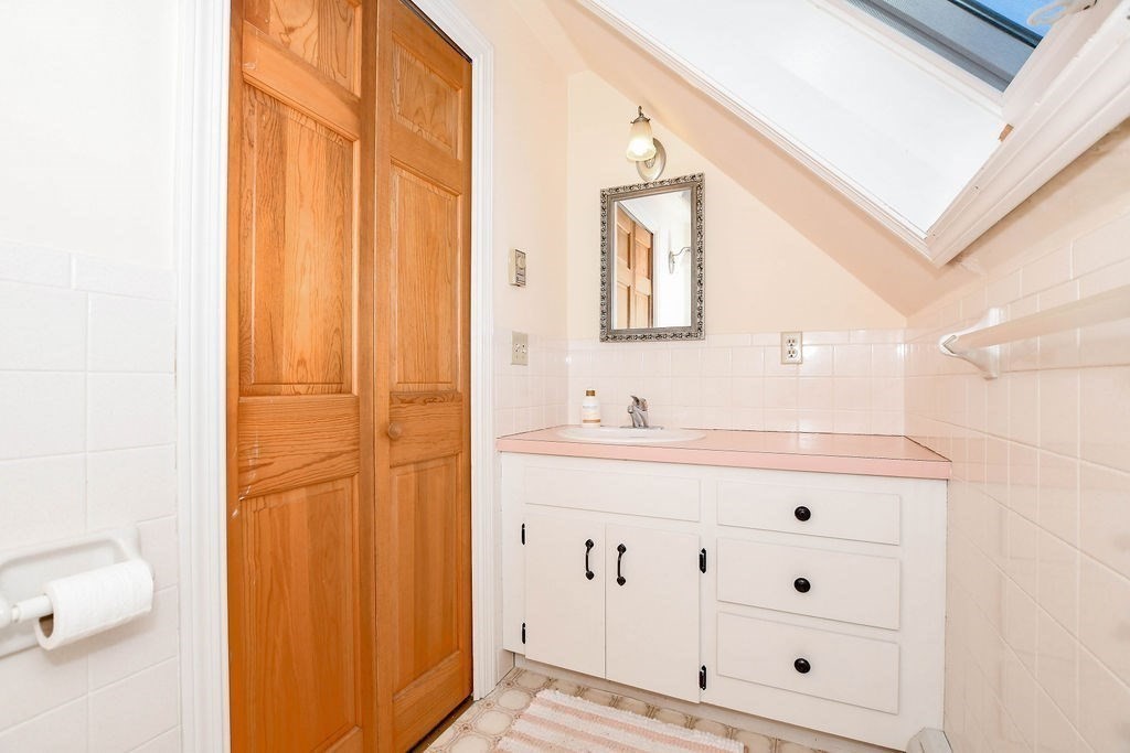 150 Herring Pond Road Bourne, MA 02532 - Photo 22 of 42 a bathroom with a sink a vanity and a mirror