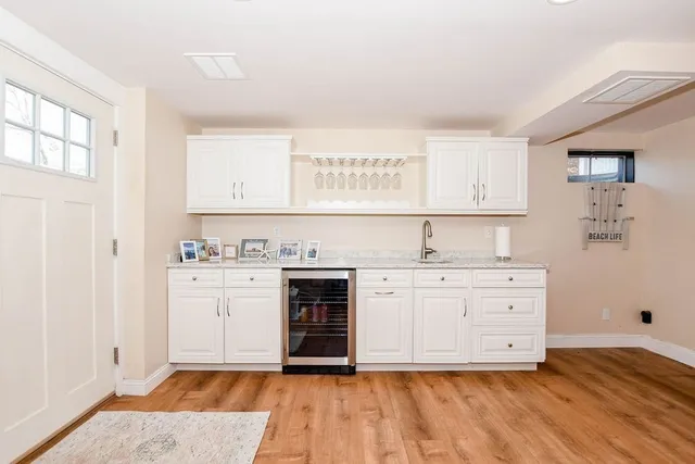 a kitchen with granite countertop a sink cabinets and stainless steel appliances