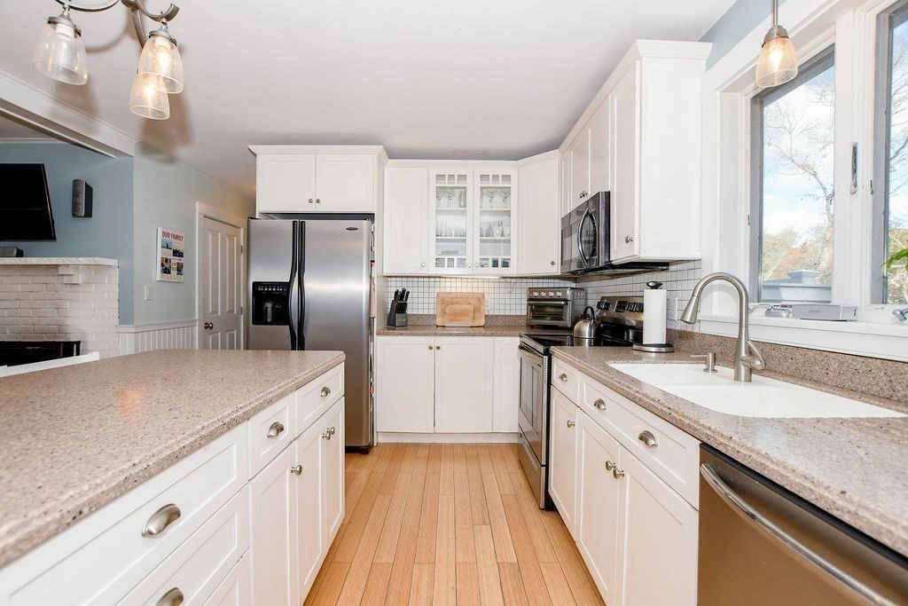 150 Herring Pond Road Bourne, MA 02532 - Photo 3 of 42 a kitchen with stainless steel appliances granite countertop a sink dishwasher a refrigerator and a stove with wooden floor