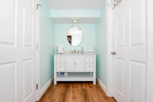 a bathroom with a sink mirror and vanity