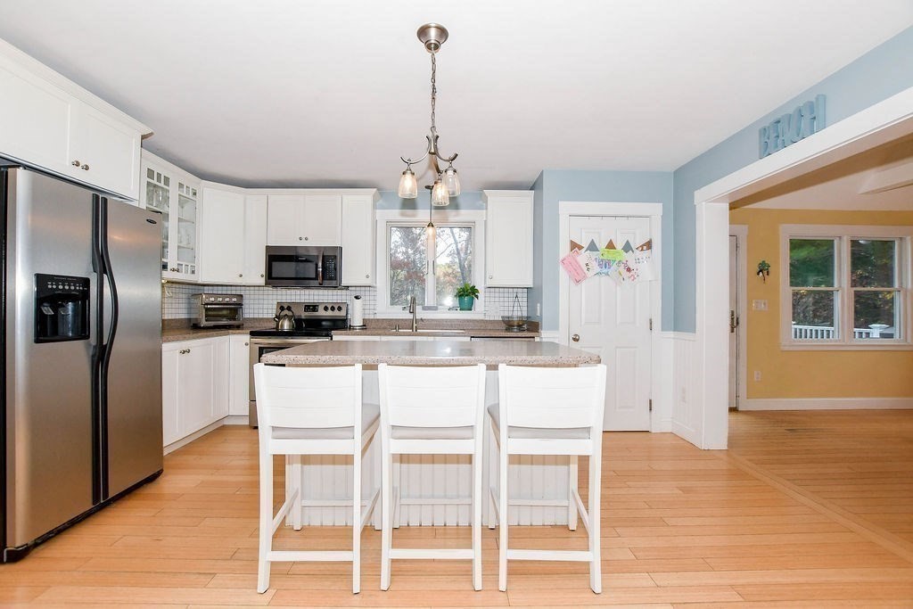 150 Herring Pond Road Bourne, MA 02532 - Photo 5 of 42 a kitchen with stainless steel appliances granite countertop a refrigerator and microwave