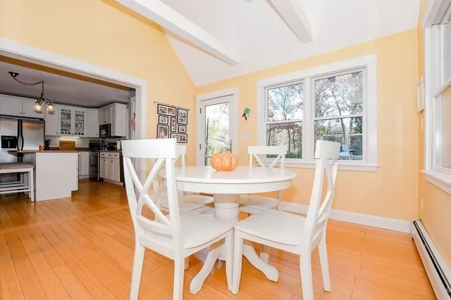 a dining room with furniture and wooden floor