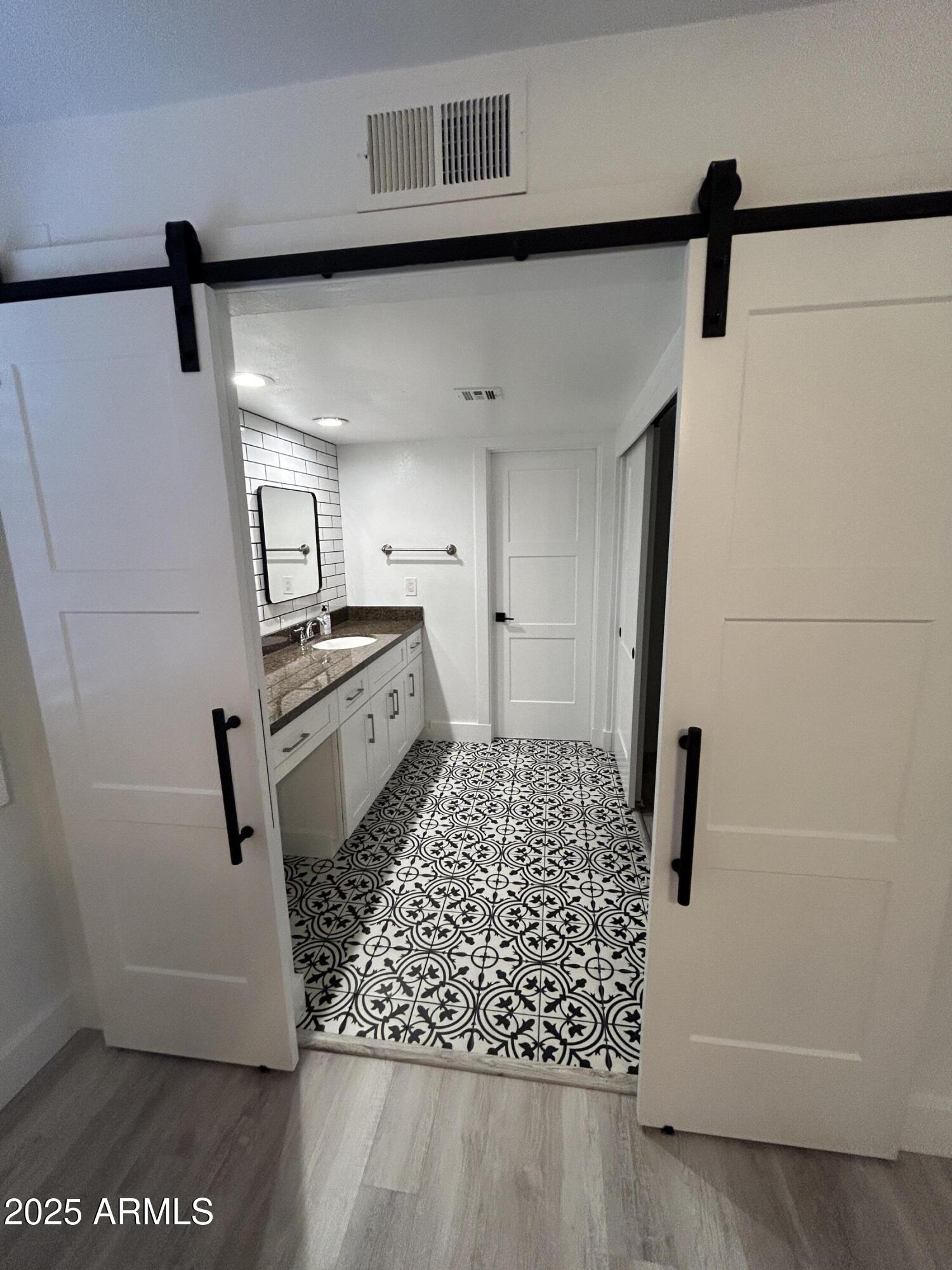 320 East Larkspur Lane Tempe, AZ 85288 - Photo 12 of 16 a kitchen with white cabinets and white appliances