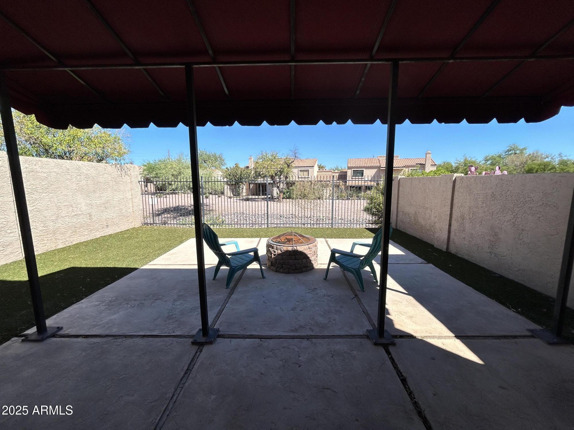 320 East Larkspur Lane Tempe, AZ 85288 - Photo 14 of 16 a view of a patio with a table chairs under an umbrella