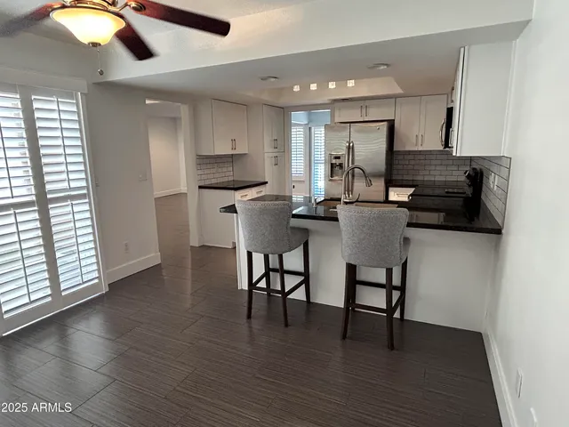 a kitchen with stainless steel appliances kitchen island granite countertop a stove a sink and a microwave