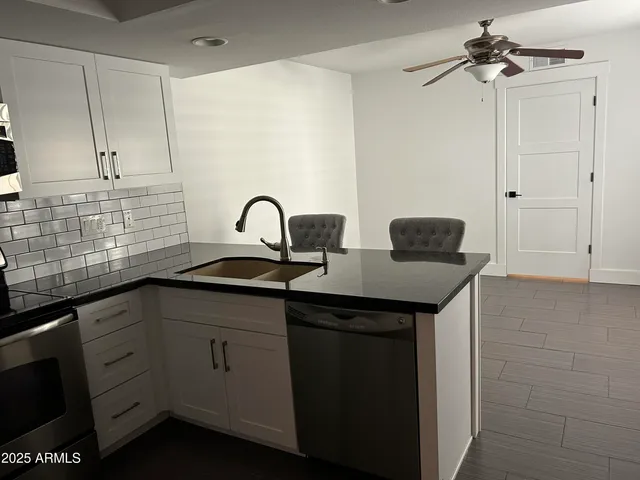 a kitchen with a sink and cabinets