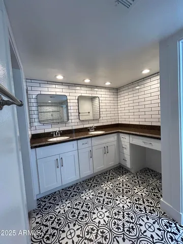 a kitchen with granite countertop white cabinets and white appliances