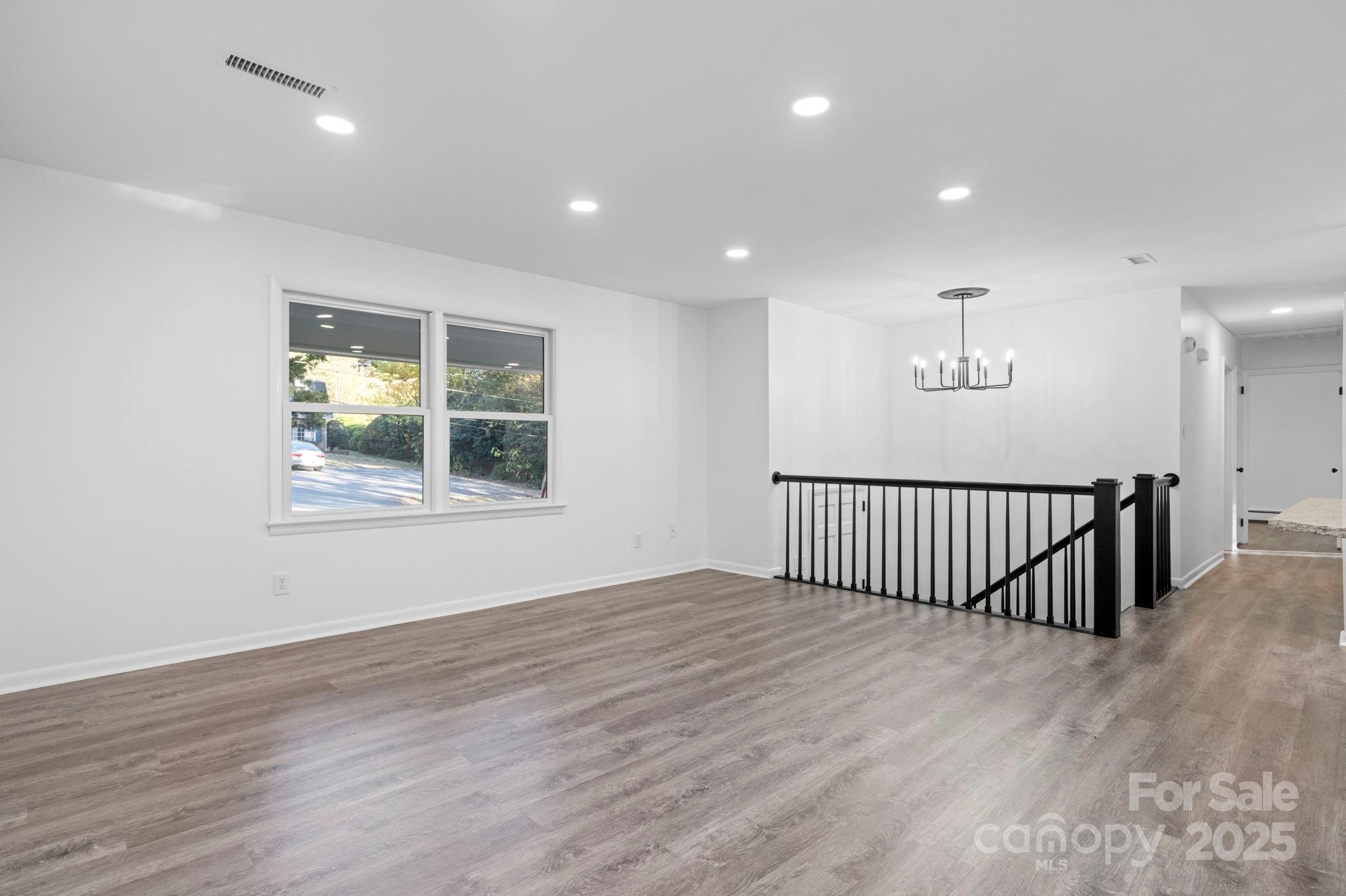 1185 10th St Pl Circle Northwest Hickory, NC 28601 - Photo 12 of 38 an empty room with wooden floor and windows