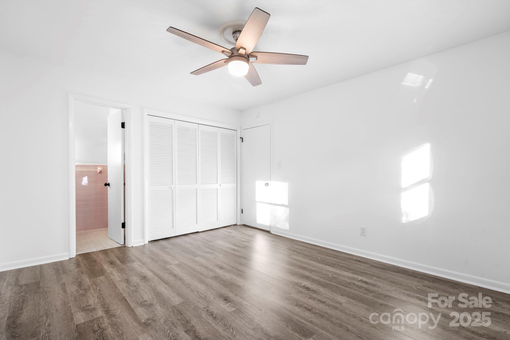 1185 10th St Pl Circle Northwest Hickory, NC 28601 - Photo 18 of 38 an empty room with wooden floor fan and windows