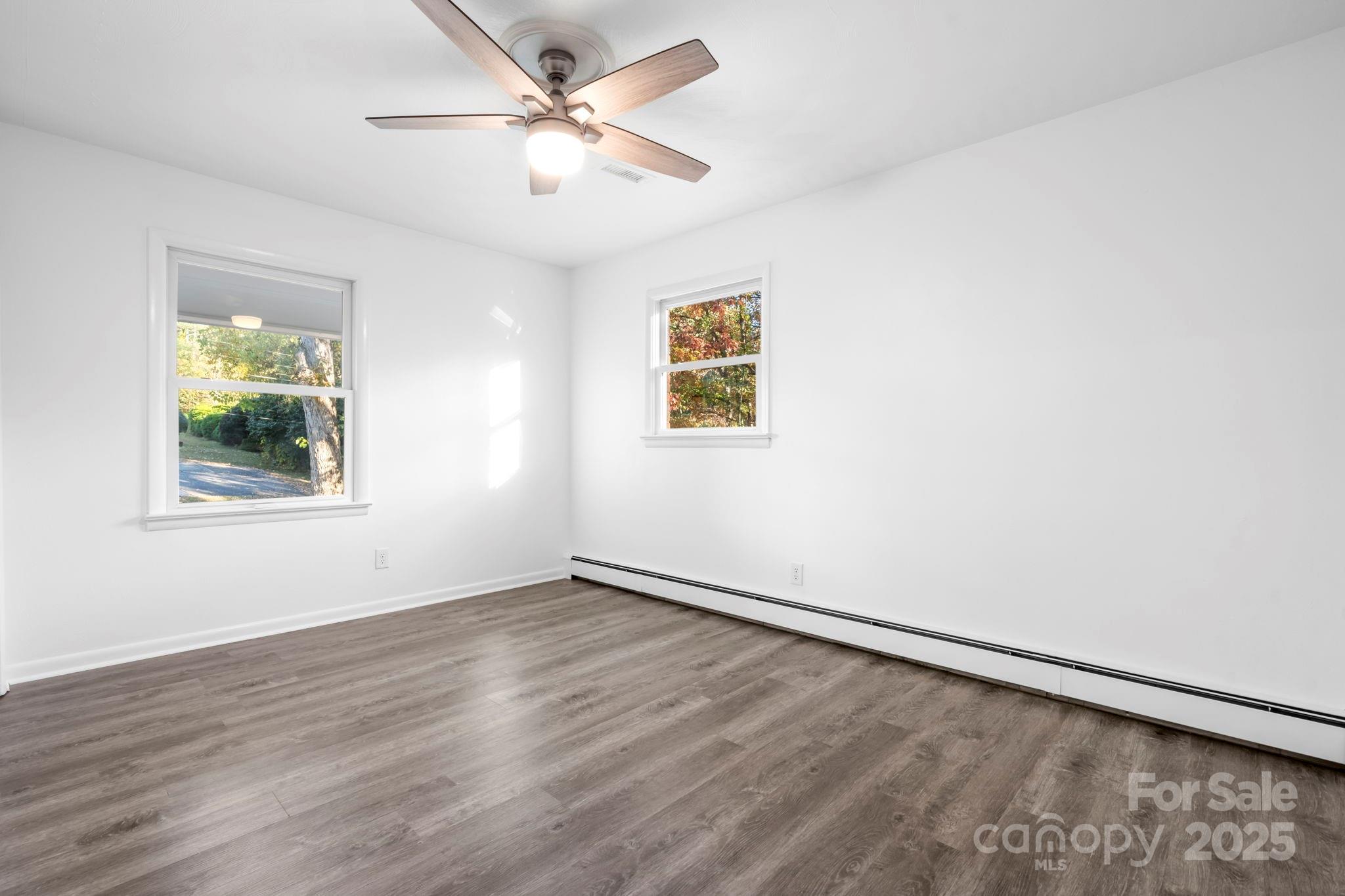 1185 10th St Pl Circle Northwest Hickory, NC 28601 - Photo 21 of 38 a view of an empty room with a window and wooden floor
