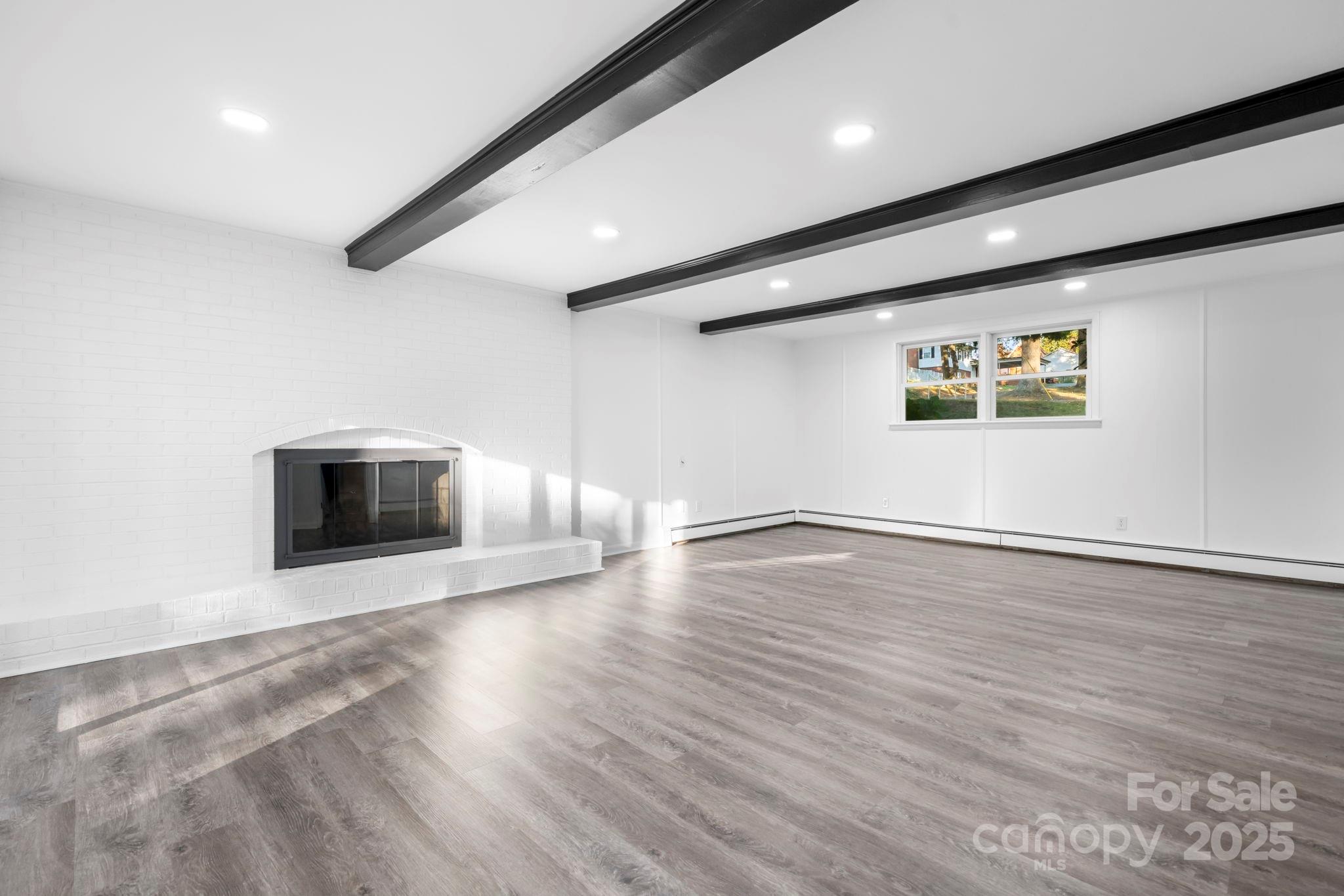 1185 10th St Pl Circle Northwest Hickory, NC 28601 - Photo 22 of 38 an empty room with wooden floor and windows