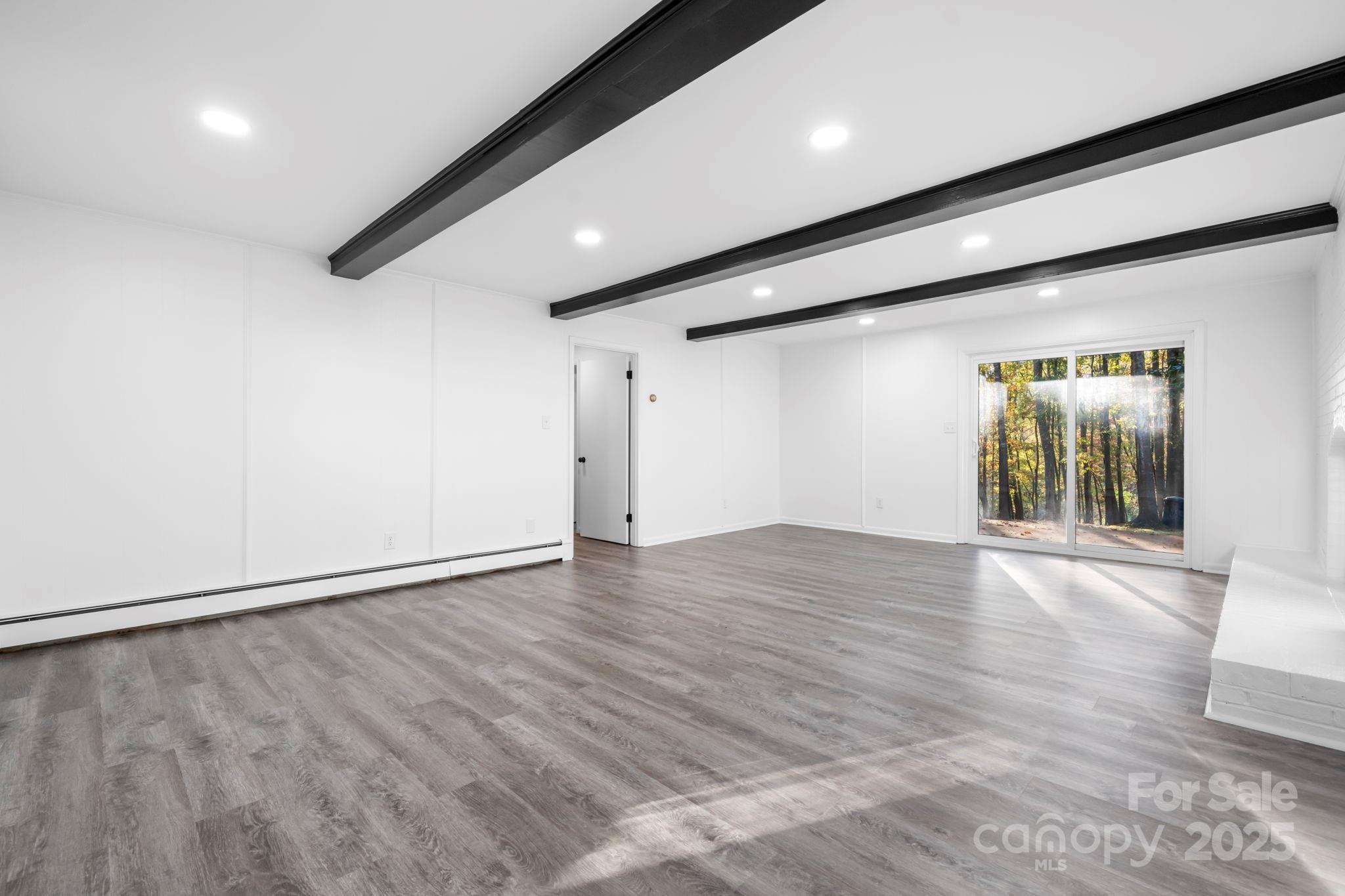 1185 10th St Pl Circle Northwest Hickory, NC 28601 - Photo 24 of 38 an empty room with wooden floor and windows