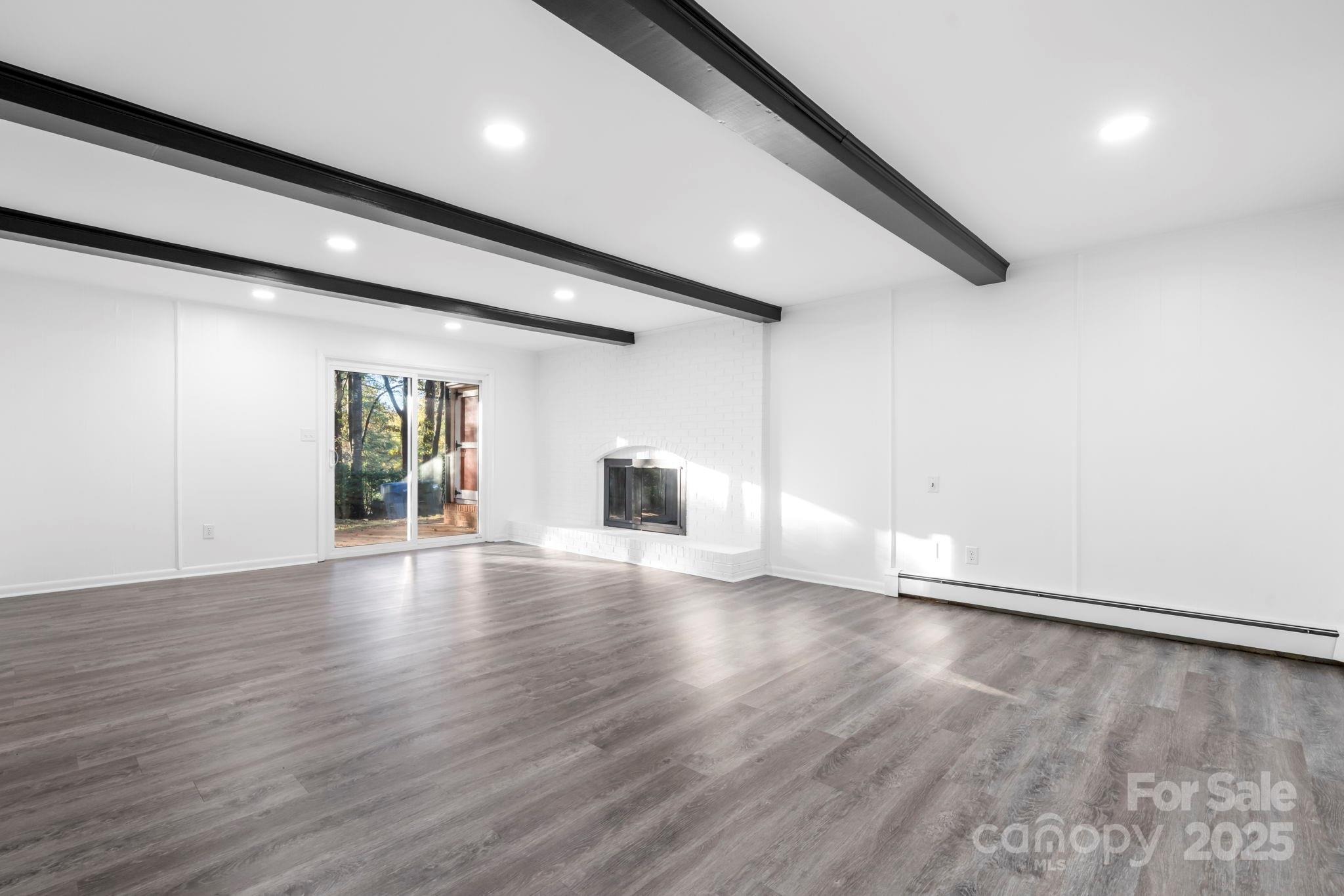 1185 10th St Pl Circle Northwest Hickory, NC 28601 - Photo 25 of 38 an empty room with wooden floor and windows