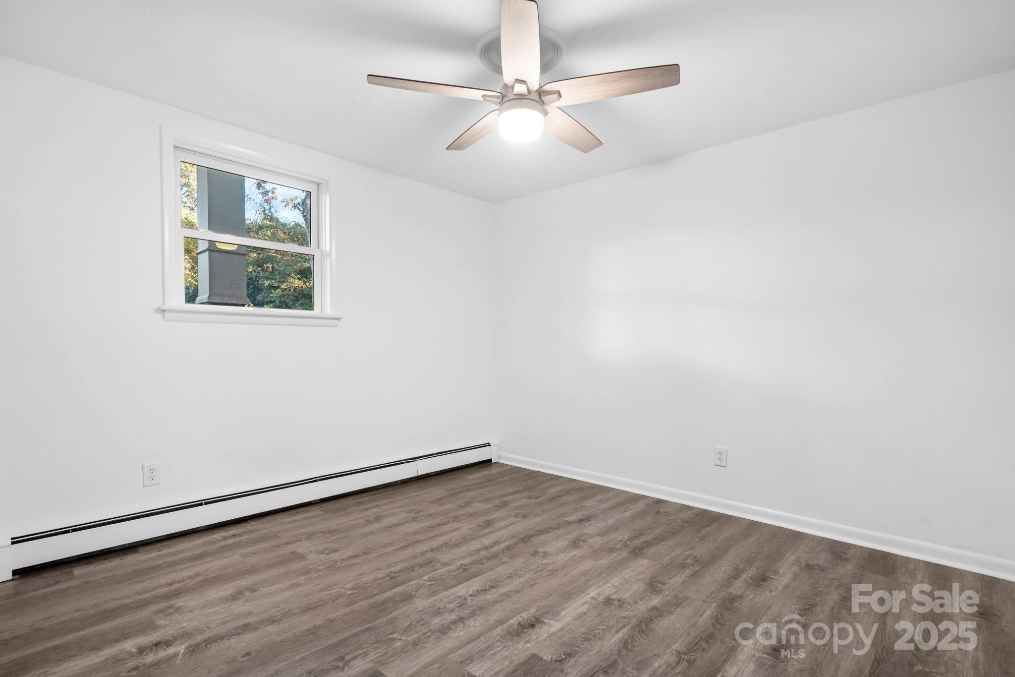1185 10th St Pl Circle Northwest Hickory, NC 28601 - Photo 27 of 38 wooden floor in an empty room with a window