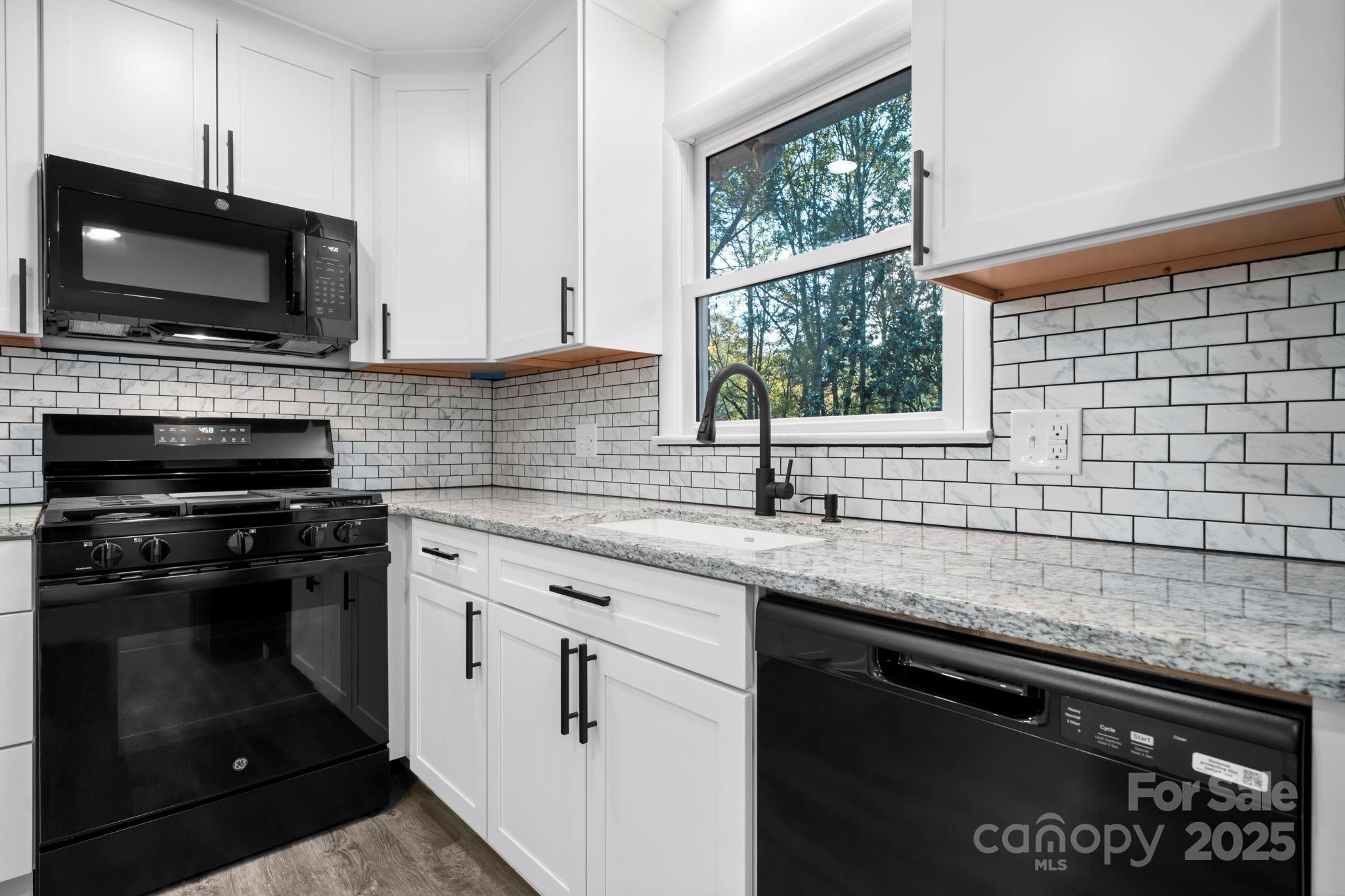 1185 10th St Pl Circle Northwest Hickory, NC 28601 - Photo 8 of 38 a kitchen with a sink stove and microwave
