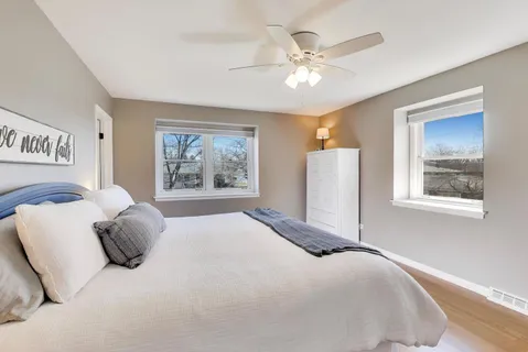 a bedroom with a large bed and a window