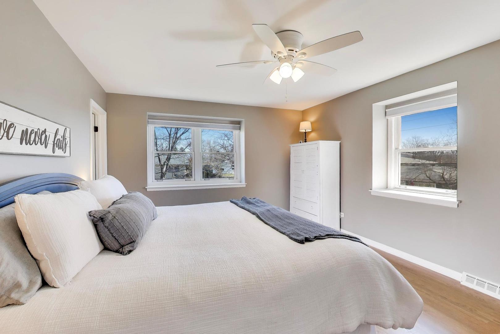 1445 Stoddard Avenue Wheaton, IL 60187 - Photo 17 of 38 a bedroom with a large bed and a window