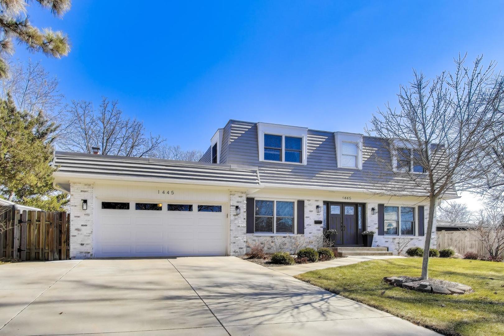 1445 Stoddard Avenue Wheaton, IL 60187 - Photo 2 of 38 a front view of a building with garden and trees