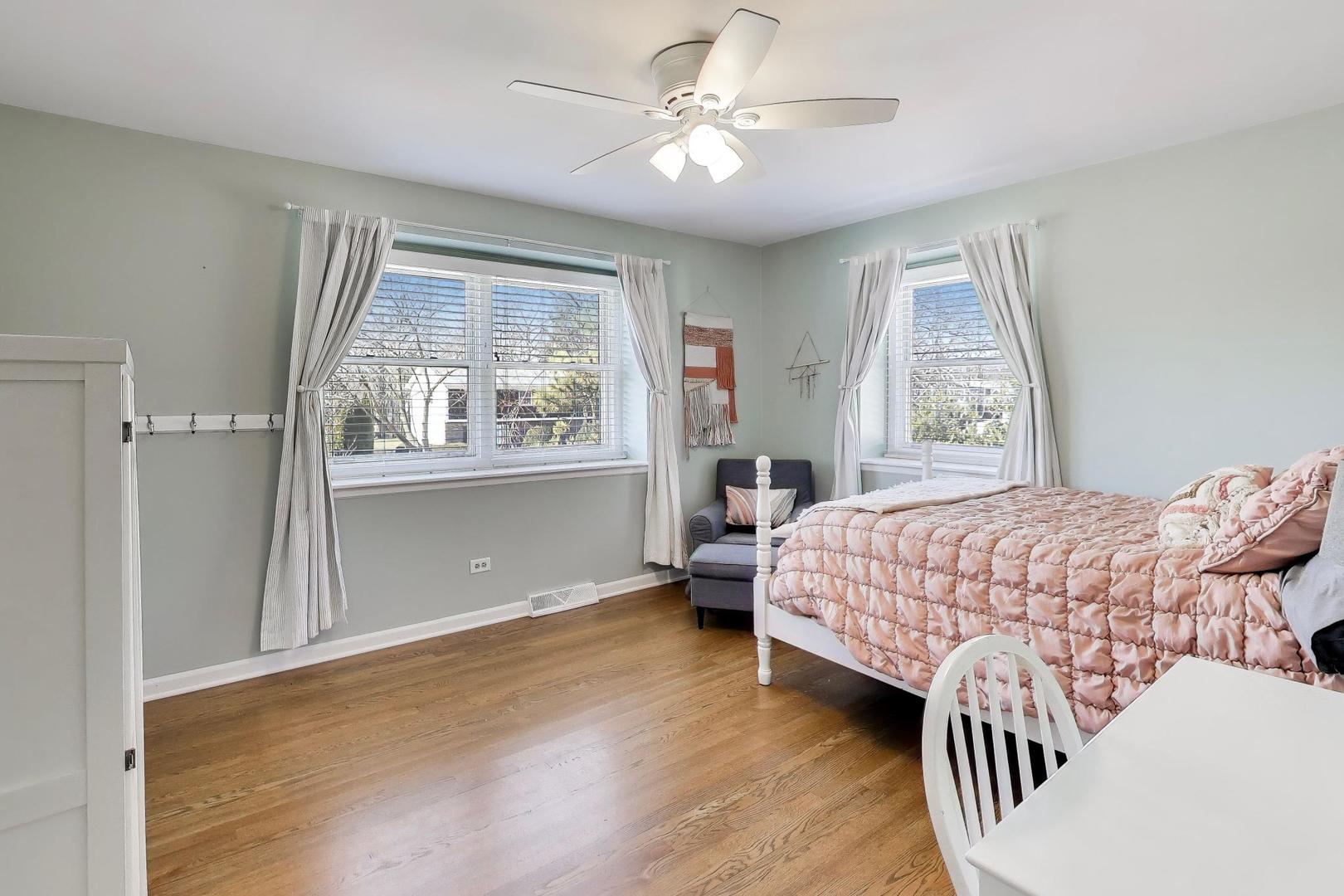 1445 Stoddard Avenue Wheaton, IL 60187 - Photo 21 of 38 a bedroom with a large bed and wooden floor