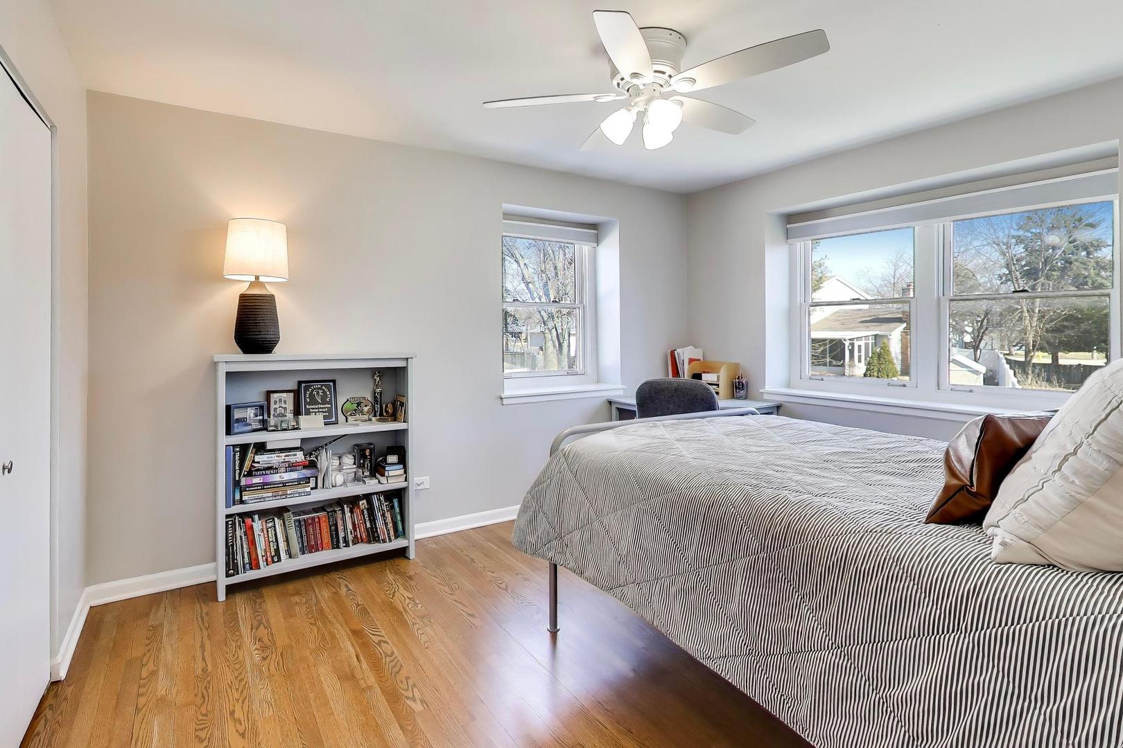 1445 Stoddard Avenue Wheaton, IL 60187 - Photo 23 of 38 a bedroom with a bed a large window and a chandelier
