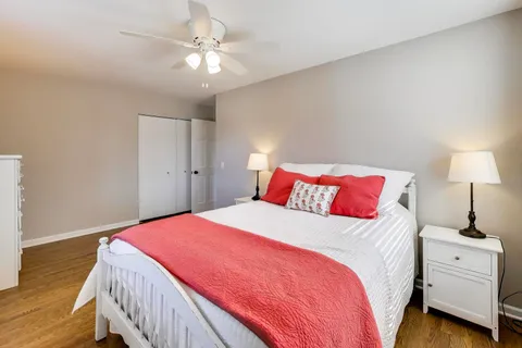 a bedroom with a large bed and a chandelier