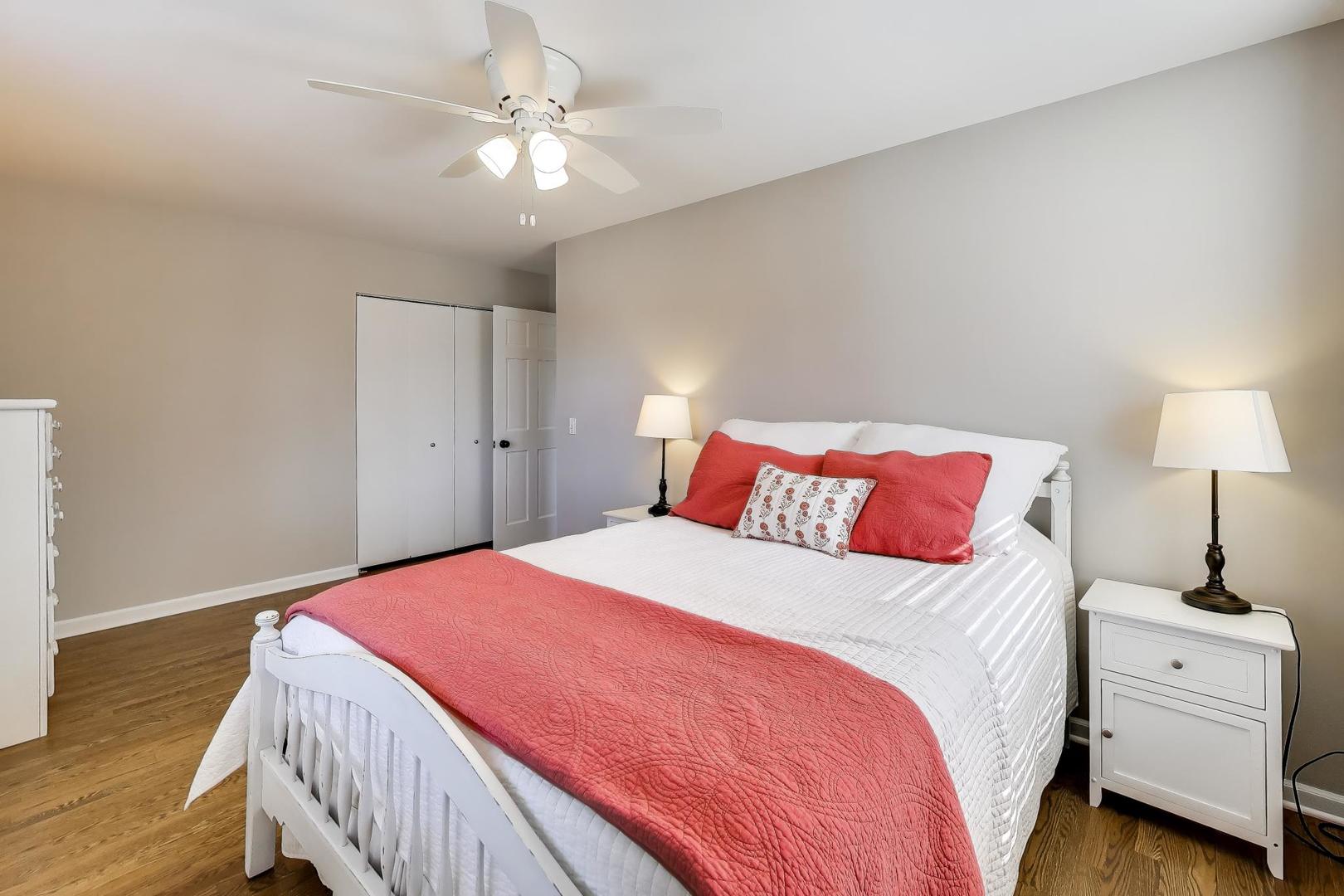 1445 Stoddard Avenue Wheaton, IL 60187 - Photo 25 of 38 a bedroom with a large bed and a chandelier