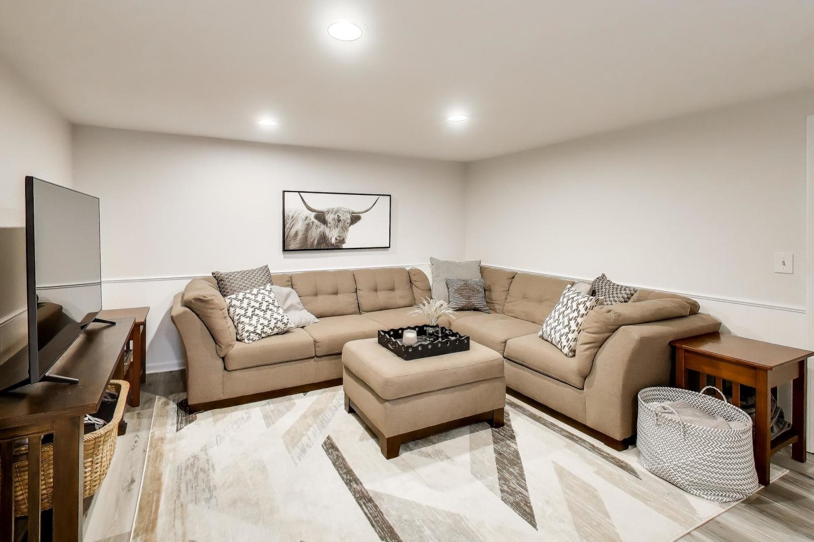 1445 Stoddard Avenue Wheaton, IL 60187 - Photo 28 of 38 a living room with furniture and a flat screen tv