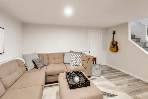a living room with furniture and painting on the wall