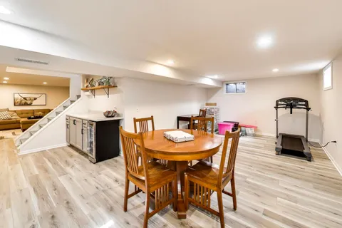 a view of a dining room with furniture and wooden floor